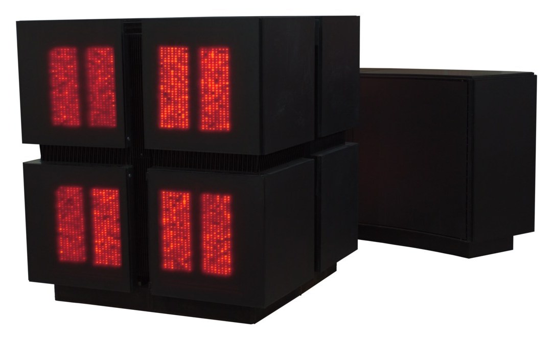 A Connection Machine CM-2 with its red LED panels lit, next to its DataVault storage unit.